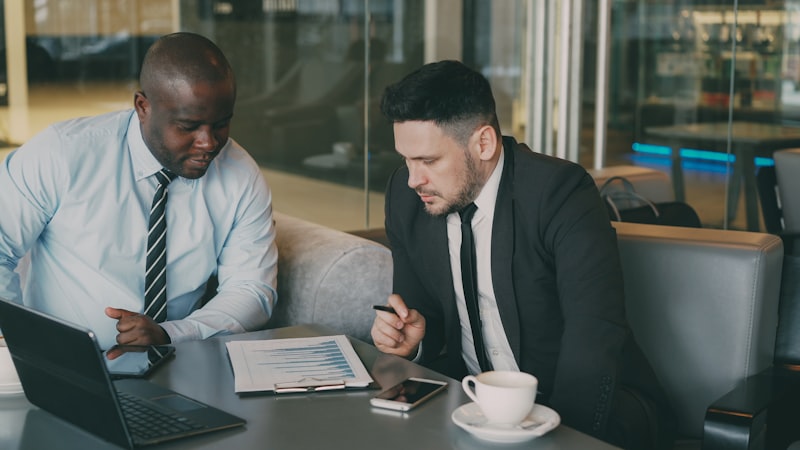 Two colleagues reviewing documents together at a table